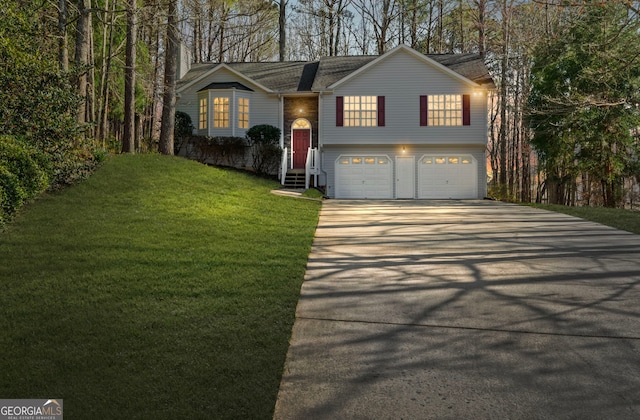 split foyer home with a shingled roof, entry steps, a front yard, a garage, and driveway