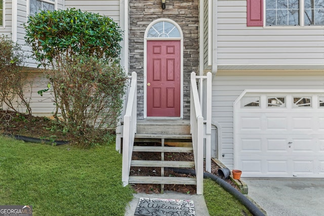 entrance to property featuring stone siding and an attached garage