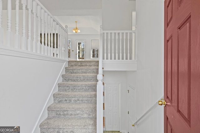 stairs featuring an inviting chandelier