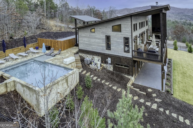 view of side of home with a patio, cooling unit, and a fenced backyard