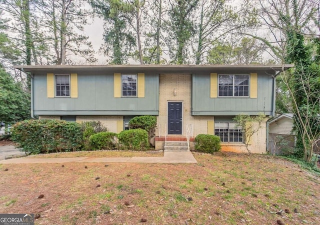 bi-level home featuring brick siding