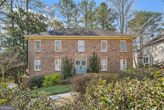 colonial-style house with brick siding