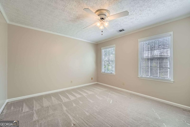 unfurnished room featuring ornamental molding, baseboards, visible vents, and carpet flooring