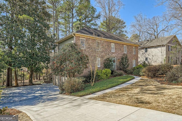 view of front of house with concrete driveway and brick siding