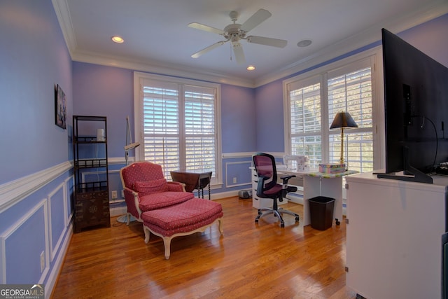 office area with a wainscoted wall, crown molding, and wood finished floors