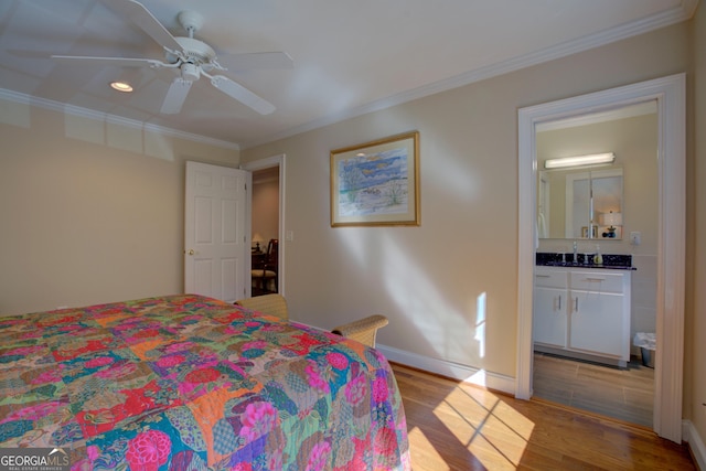 bedroom with ornamental molding, ensuite bath, light wood-style flooring, and baseboards