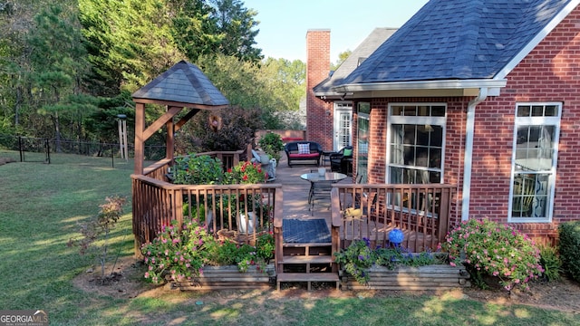 wooden terrace featuring fence and a lawn