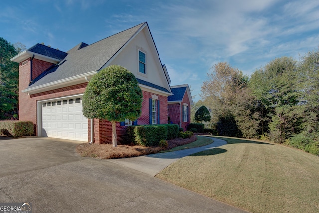 view of front of house with a garage, a front lawn, concrete driveway, and brick siding