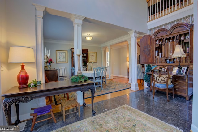 entrance foyer featuring decorative columns, baseboards, a towering ceiling, ornamental molding, and marble finish floor