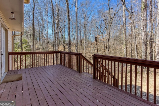 wooden terrace with a wooded view