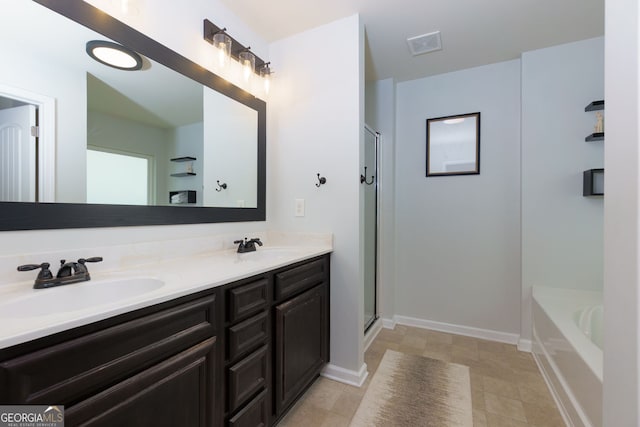 full bathroom featuring an enclosed shower, visible vents, double vanity, and a sink