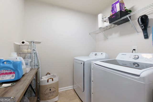 laundry area with laundry area, light tile patterned floors, separate washer and dryer, and baseboards