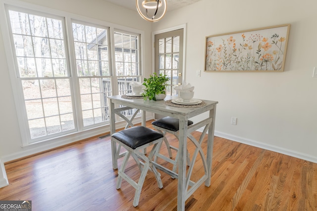 dining area with visible vents, baseboards, and wood finished floors