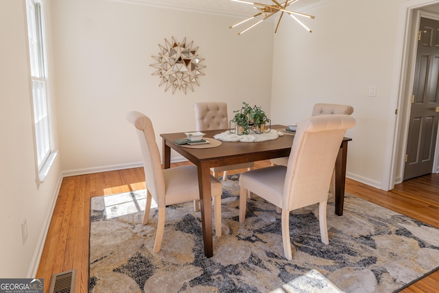 dining space with wood finished floors and a healthy amount of sunlight