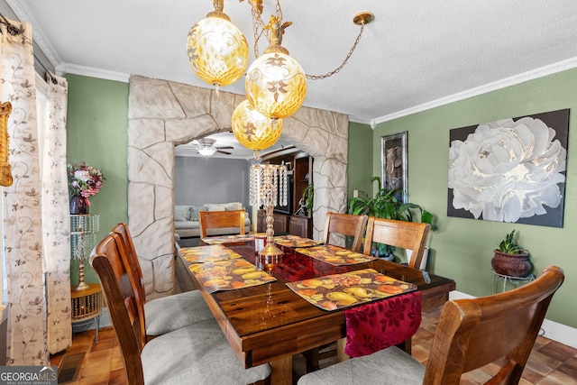 dining room featuring arched walkways, a textured ceiling, visible vents, baseboards, and crown molding