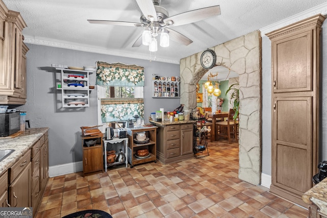 bar featuring arched walkways, a textured ceiling, ceiling fan with notable chandelier, baseboards, and crown molding