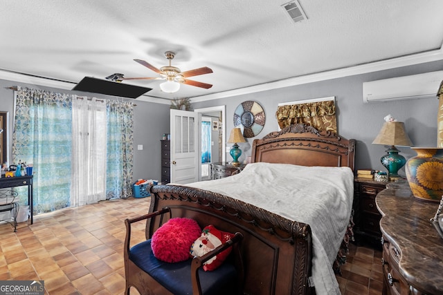 bedroom featuring visible vents, ornamental molding, a ceiling fan, a textured ceiling, and a wall mounted air conditioner