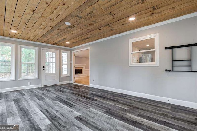 unfurnished living room featuring a fireplace, wood ceiling, baseboards, ornamental molding, and dark wood finished floors