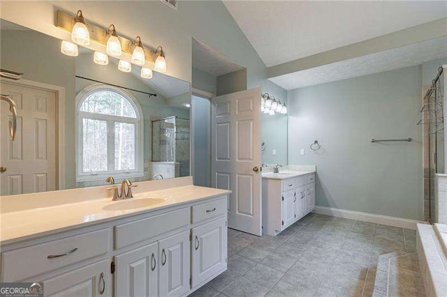 full bathroom with lofted ceiling, two vanities, a sink, baseboards, and a shower stall