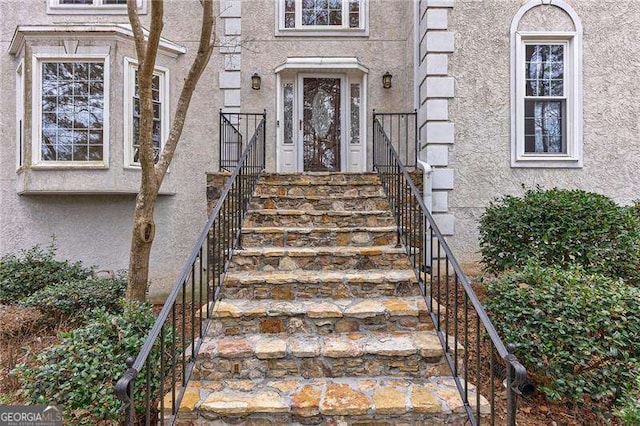 entrance to property with stucco siding