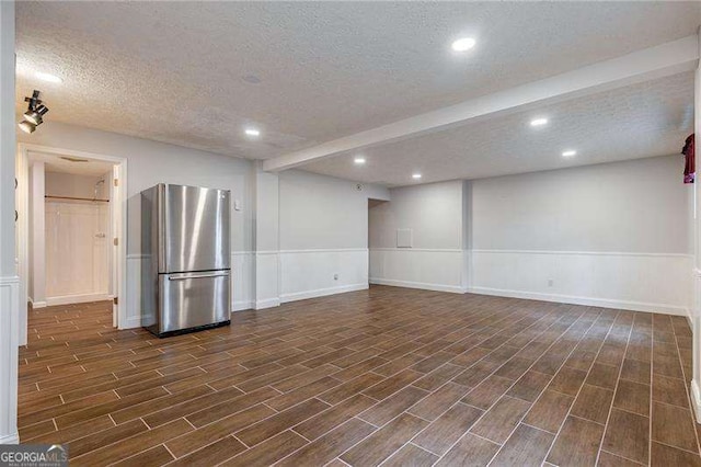 interior space featuring wainscoting, recessed lighting, a textured ceiling, and wood finish floors