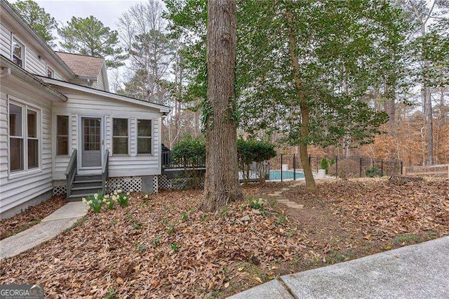 view of yard with entry steps and fence