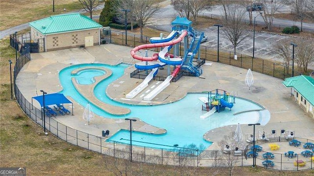 view of swimming pool featuring fence and a patio