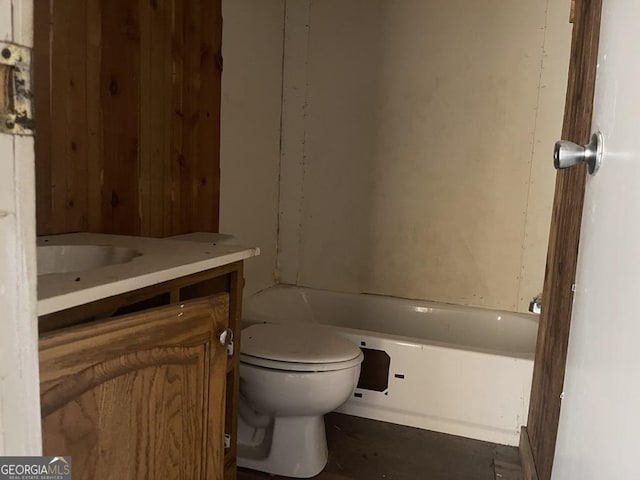 full bathroom with vanity, toilet, and a tub