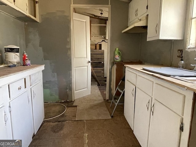 kitchen featuring light countertops and white cabinets