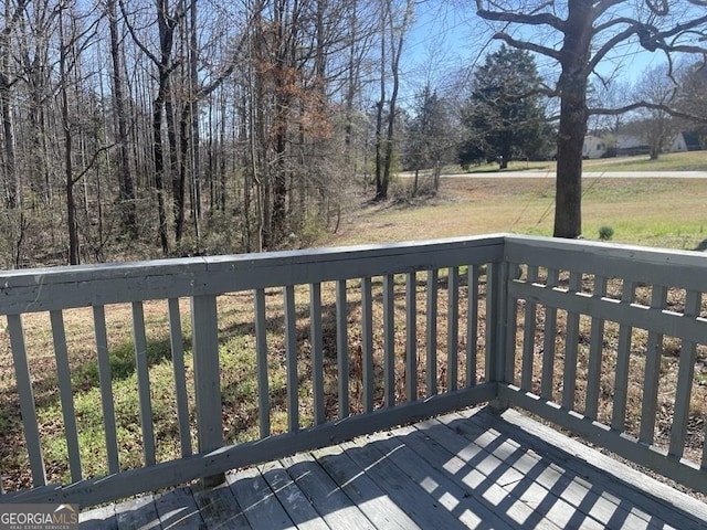 wooden deck with a yard