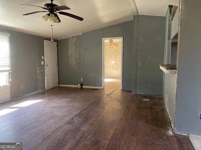 unfurnished living room featuring lofted ceiling, hardwood / wood-style flooring, and a ceiling fan