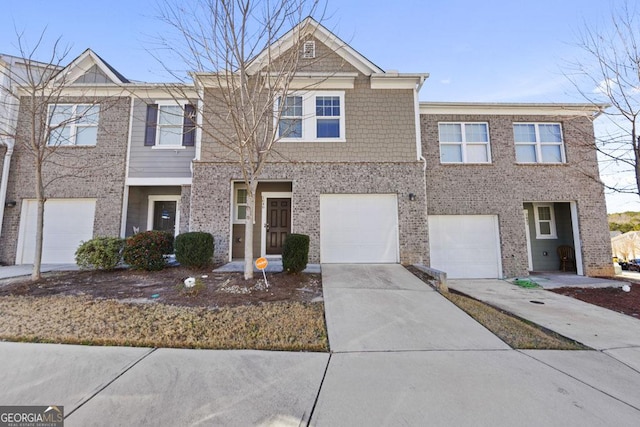 multi unit property featuring brick siding, an attached garage, and concrete driveway