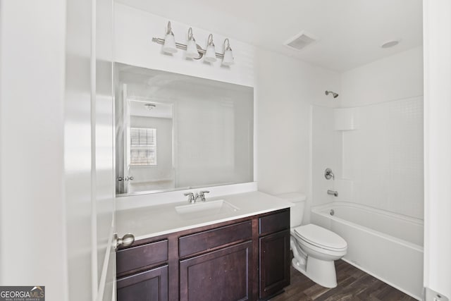 full bath featuring vanity, wood finished floors, visible vents, toilet, and shower / bathtub combination