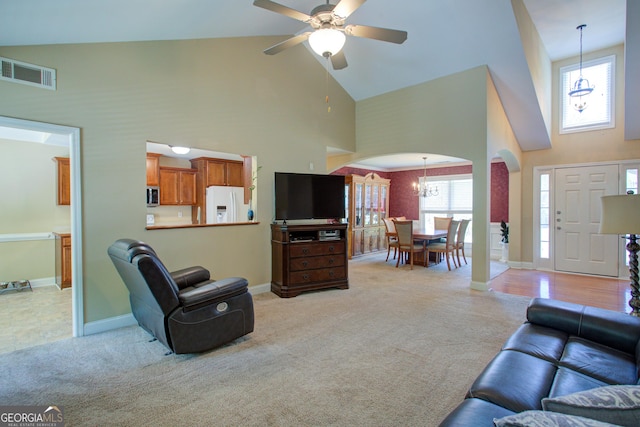 6935 Autumn Hills Dr, Cumming, GA 30028 - living room with high vaulted ceiling, arched walkways, light carpet, baseboards, and visible vents