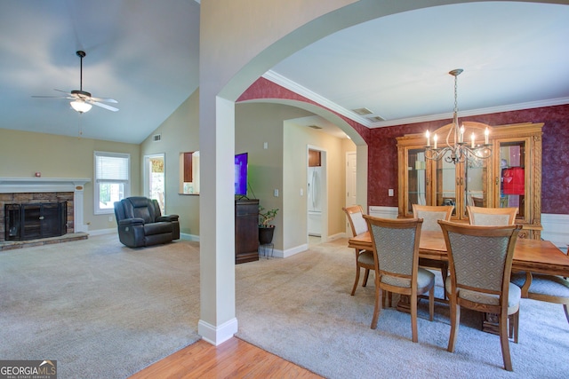 6935 Autumn Hills Dr, Cumming, GA 30028 - dining area with carpet, baseboards, a stone fireplace, and ceiling fan with notable chandelier