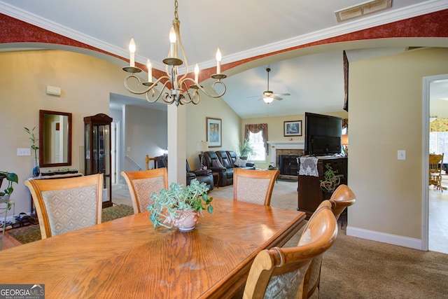 dining space with arched walkways, visible vents, ceiling fan with notable chandelier, and carpet