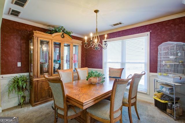 dining area featuring visible vents, a notable chandelier, a wainscoted wall, and light colored carpet