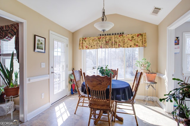 dining area with lofted ceiling, baseboards, visible vents, and a wealth of natural light