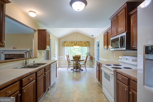 6935 Autumn Hills Dr, Cumming, GA 30028 - kitchen featuring a sink, baseboards, lofted ceiling, white appliances, and decorative light fixtures