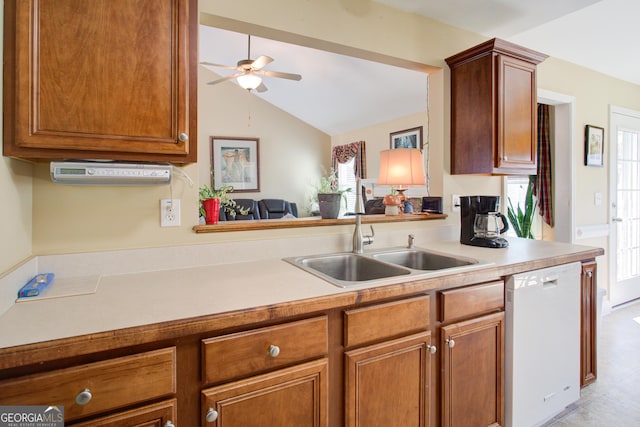 kitchen with brown cabinetry, ceiling fan, a sink, light countertops, and dishwasher