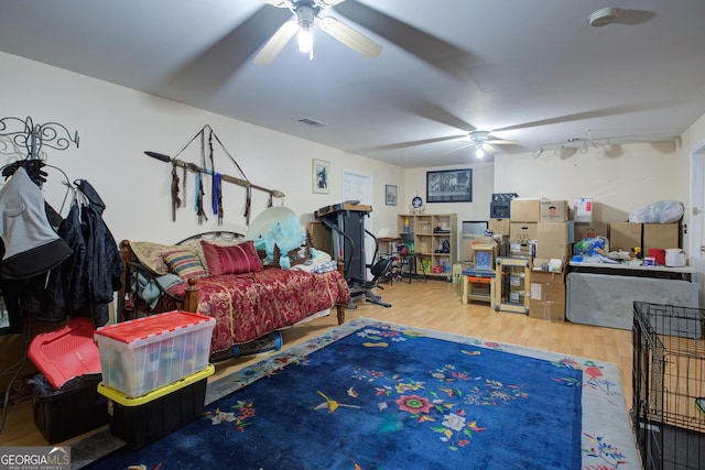 interior space featuring visible vents, wood finished floors, and a ceiling fan