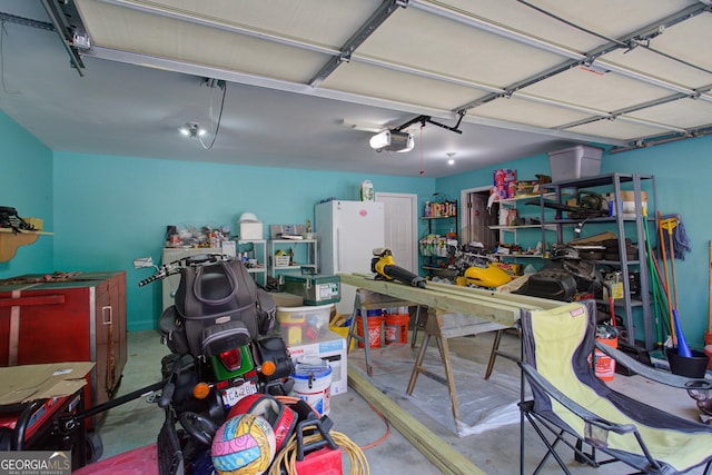 garage featuring a garage door opener and freestanding refrigerator