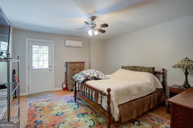 6935 Autumn Hills Dr, Cumming, GA 30028 - bedroom with a wall mounted AC, light wood-style floors, a ceiling fan, and baseboards