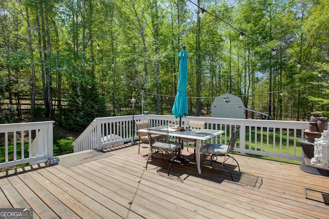 6935 Autumn Hills Dr, Cumming, GA 30028 - deck with outdoor dining space, an outbuilding, and a shed