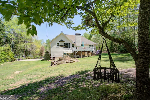 6935 Autumn Hills Dr, Cumming, GA 30028 - rear view of house with a wooden deck, a lawn, a chimney, and stairs