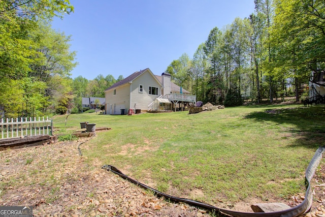 6935 Autumn Hills Dr, Cumming, GA 30028 - view of yard featuring a wooden deck, fence, and a garage