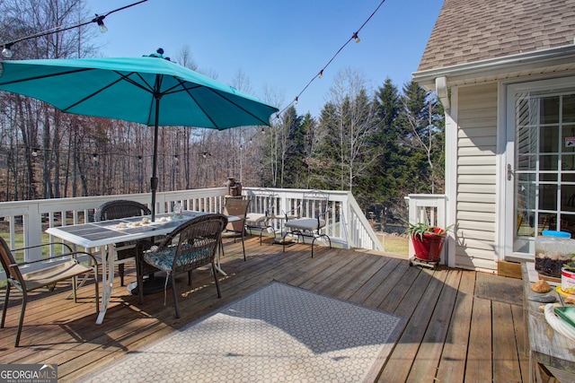 wooden deck with outdoor dining space