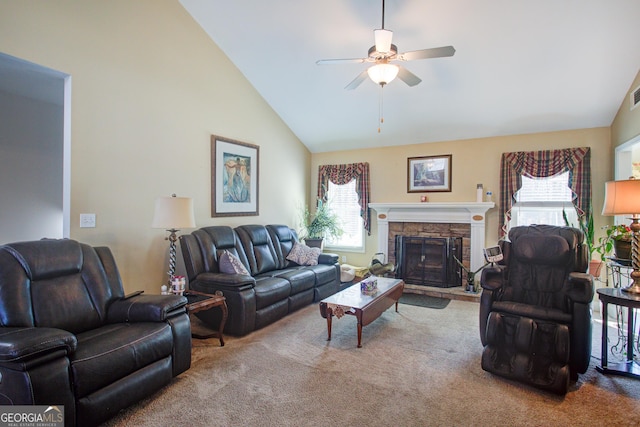 carpeted living area with high vaulted ceiling, a healthy amount of sunlight, ceiling fan, and a fireplace