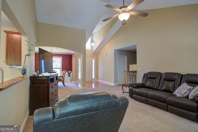 6935 Autumn Hills Dr, Cumming, GA 30028 - living area with light carpet, arched walkways, high vaulted ceiling, and ceiling fan