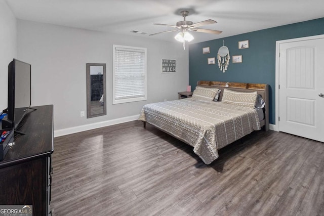 bedroom with visible vents, ceiling fan, baseboards, and wood finished floors